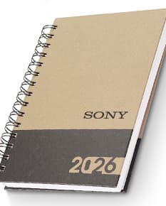 Agenda Diária 2025 com capa dura preta, marcador de página e páginas em branco para anotações.